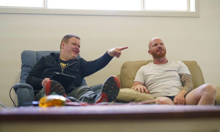 Supported Independent Living Client communicating with his Support Worker by pointing.