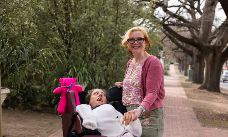High Intensity Support Client looking at Support Worker who is smiling at the camera.